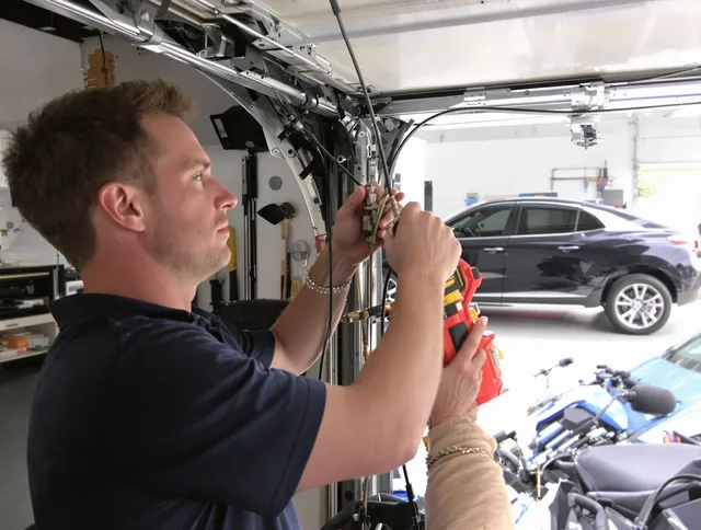 Tolland Garage Door Repair safety certified technician performing cable replacement in Tolland