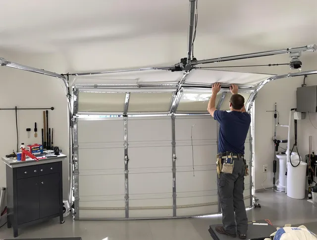 Tolland Garage Door Repair specialist performing precise section replacement on Tolland garage door